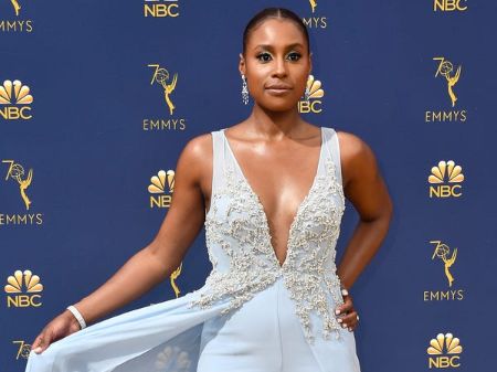 Issa Rae in a light blue dress poses at the Emmy awards.